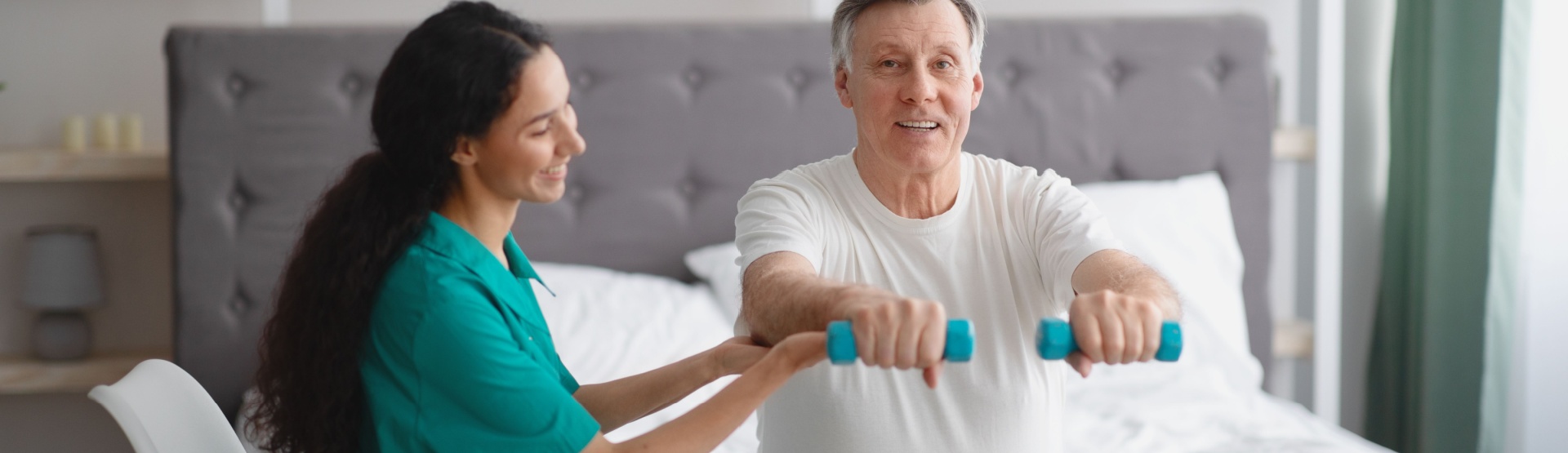Nurse helping man with weights